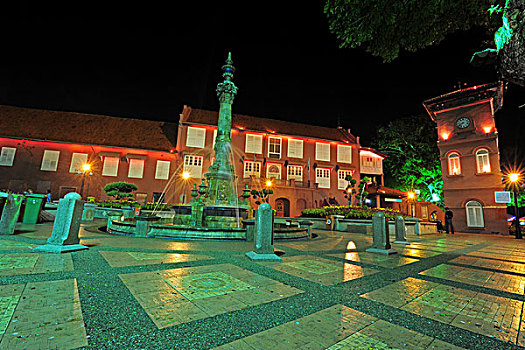 malaysia,melaka,town,square,with,clock,tower,next,to,christ,church,by,night