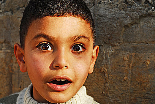 algeria,algiers,close-up,portrait,of,a,boy,showing,anxiety,by,wall