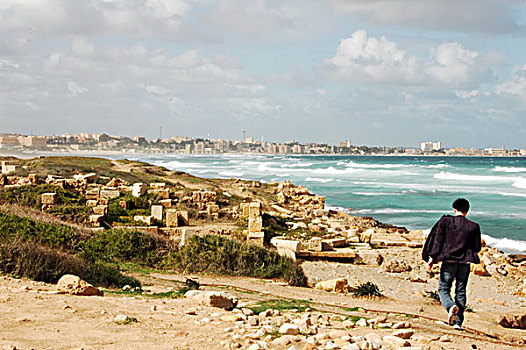 libya,leptis,magna,back,of,man,walking,through,the,ruins