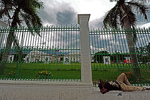 haiti,port,au,prince,homeless,man,sleeping,in,front,of,presidential,palace