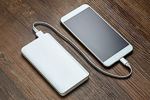 充电宝和智能手机放在木桌上