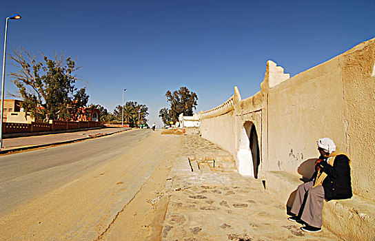 libya,ghadames,man,sitting,outside,wall,of,old,city,unesco,world,heritage,site