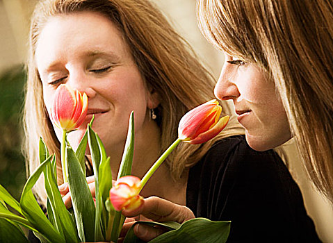 两个女人,嗅,花