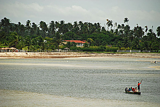 brazil,pernambuco,ilha,de,itamaraca,people,crossing,to,sossego,on,wooden,canoe,boat