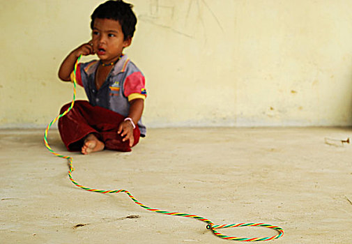 dominica,carib,territory,little,boy,with,colorful,necklace,playing,rope