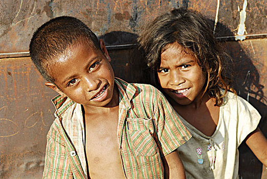 east-timor,timor-leste,dili,portrait,timorese,boy,and,girl,with,iron,background,rust