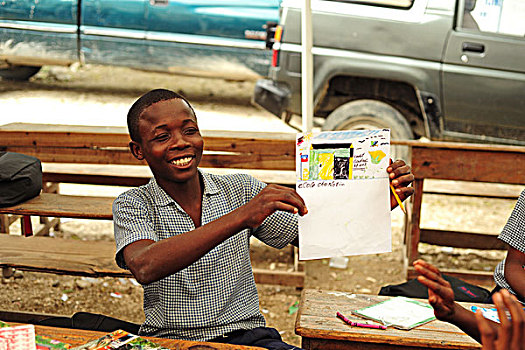 haiti,croix,des,bouquets,boy,showing,his,drawing