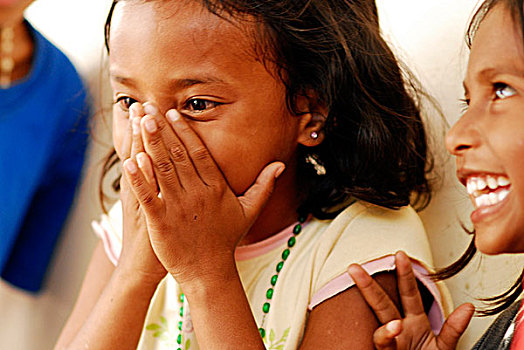timorese,girl,in,blue,dress,surprised,and,scared,with,her,hands,face