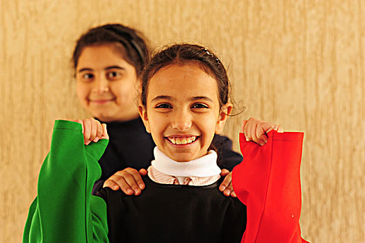 kuwait,city,portrait,of,2,smiling,girls,disguised,with,kuweiti,flag