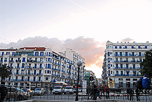 algeria,algiers,people,crossing,the,road,with,cars,and,buildings,against,sky