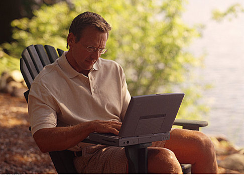 男人,坐,椅子,使用笔记本,电脑,靠近,湖