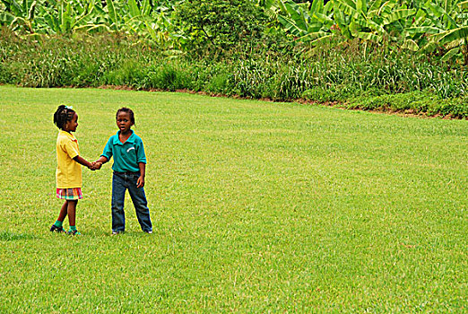 dominica,carib,territory,children,playing,soccer,at,a,school,fair,with,respect,yellow,t-shirt