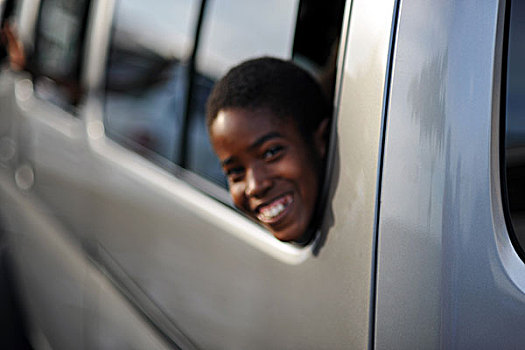 dominica,roseau,smiling,child,out,of,focus,from,minibus