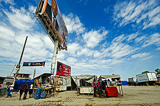 haiti,port,au,prince,presidential,campaign,advertisement,in,front,of,refugee,camp