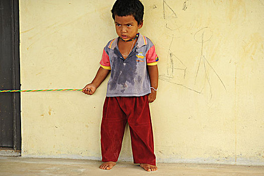 dominica,carib,territory,little,boy,with,colorful,necklace,playing,rope