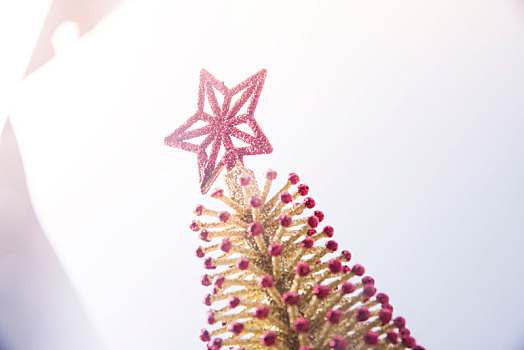 低视角看到暖色光线中的圣诞树树顶星