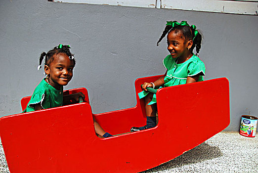 dominica,roseau,preschool,social,center,young,schoolgirls,playing,on,swing