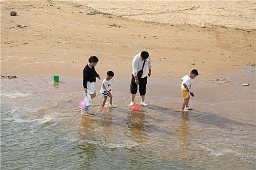 山东省日照市,太公岛游人如织,赶海拾贝做游戏乐在其中