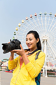 年轻女人在游乐园摄影