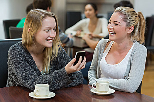 女人,坐,咖啡馆,看,智能手机,微笑