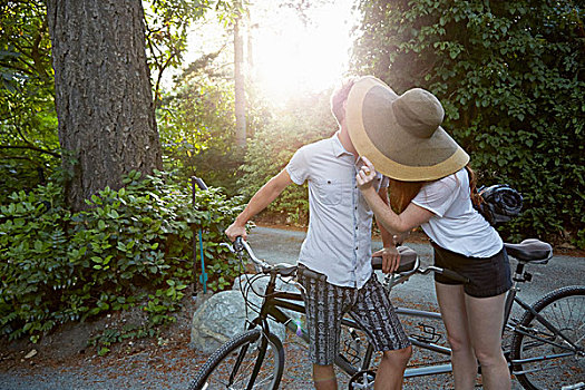 年轻,情侣,一前一后,自行车,吻,乡村道路