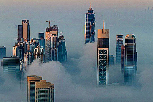 登迪拜哈里发塔雾云中看迪拜城