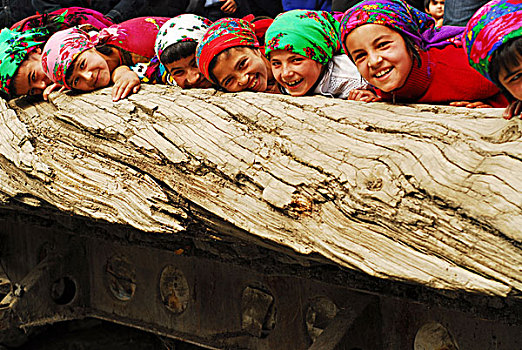 tajikistan,penjakent,group,of,local,girls,in,traditional,dress,playing,by,the,river