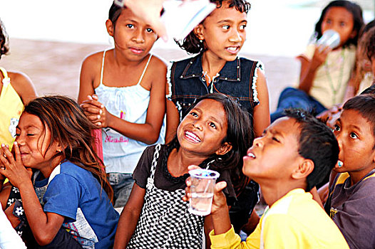 timorese,girl,with,plastic,glass,in,her,mouth