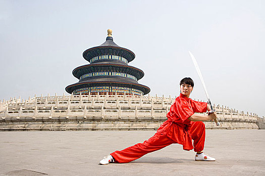 中国武术--一名女武术运动员在天坛祈年殿前练刀法