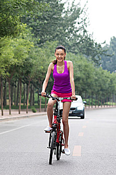 青年女性在马路上骑自行车