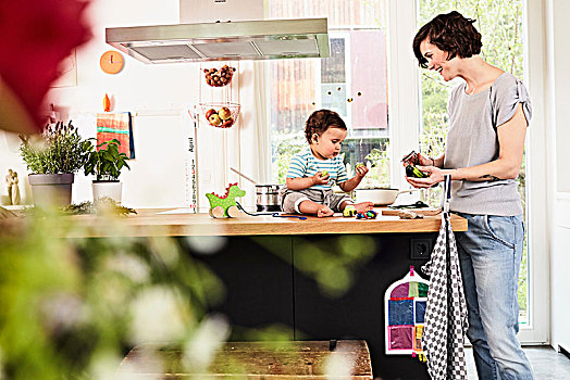 婴儿,女儿,坐,厨房操作台,看,母亲,准备,蔬菜