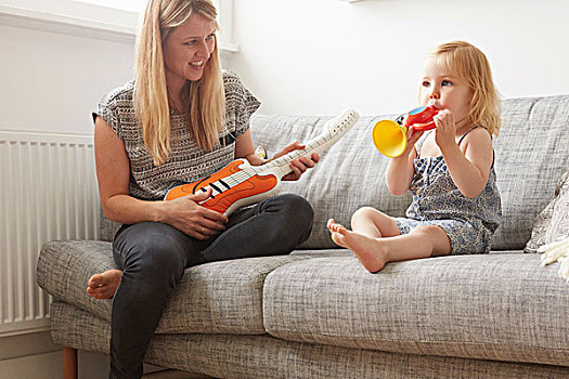 女性,幼儿,母亲,演奏,玩具,喇叭,吉他,沙发