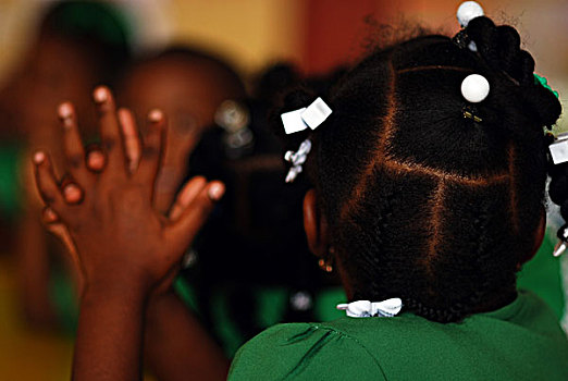 dominica,roseau,preschool,social,center,rear,portrait,of,girl,with,braids