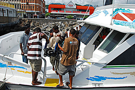 dominica,roseau,handicapped,boy,in,a,wheelchair,embarking,for,whales,and,dolphin,tour,part,of,the,unicef,-,environmental,network,whalewat