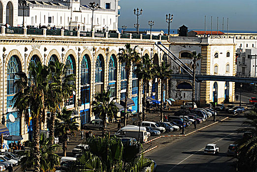 algeria,alger,high,angle,view,of,car,parked,in,lot,by,hotel,with,vehicles,moving,on,road,foreground