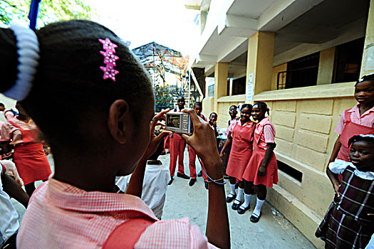 haiti,port,au,prince,schoolgirl,taking,a,photograph