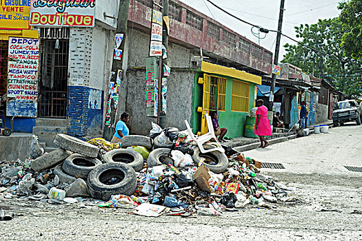 haiti,port,au,prince,people,cleaning,the,plastic,garbage,in,front,of,green,house