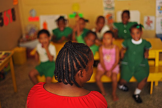 dominica,roseau,preschool,social,center,teacher,in,classroom,with,children