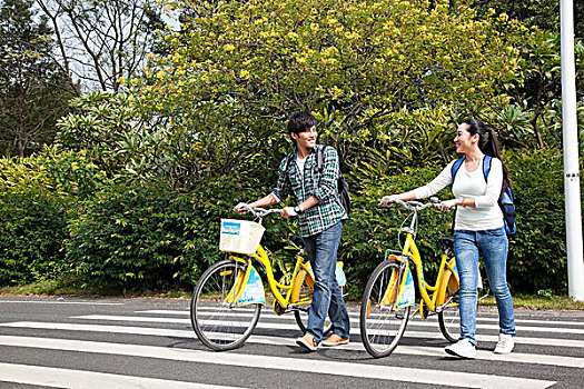 年轻大学生在校园里推车