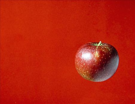 红苹果,红色背景