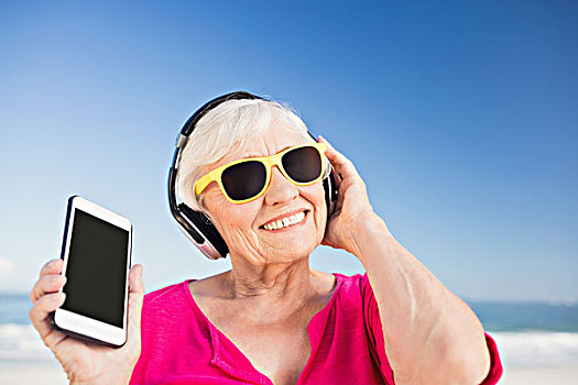 老年,女人,听,音乐,头戴式耳机,海滩