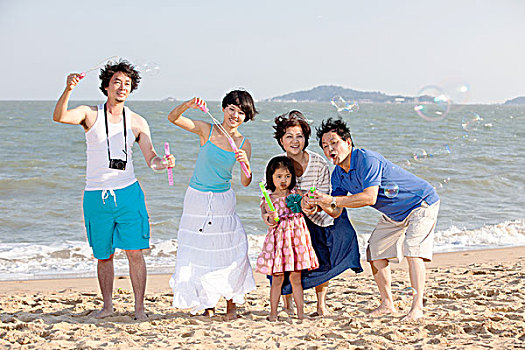 东方家庭在海边玩耍嬉戏