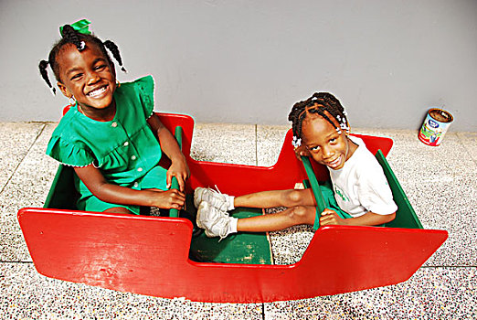 dominica,roseau,preschool,social,center,young,schoolgirls,playing,on,swing