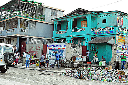 haiti,port,au,prince,people,cleaning,the,plastic,garbage,in,front,of,green,house