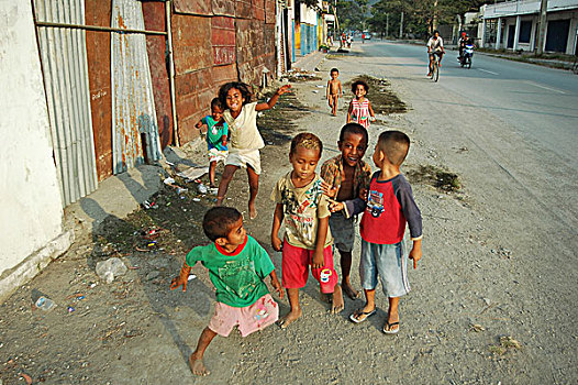 group,of,timorese,children,in,the,street,with,naked,boy,background