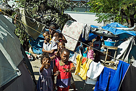 haiti,port,au,prince,portrait,of,children,in,front,laundry,tent,refugee,camp