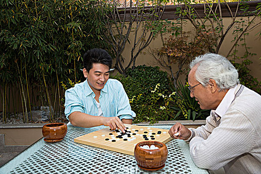 父子在庭院里下棋