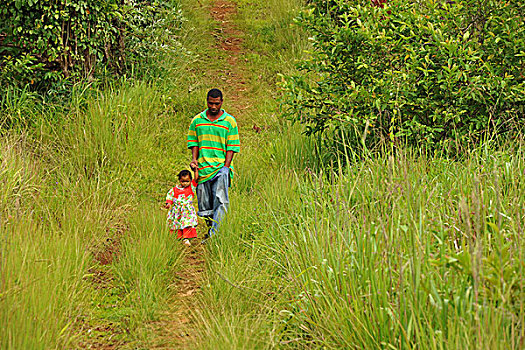 dominica,carib,territory,father,and,little,daughter,walking,through,the,lawn