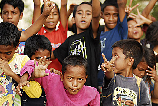 east-timor,timor-leste,dili,4,four,timorese,men,smiling,at,the,camera,with,different,skin,color,-,3,blurred