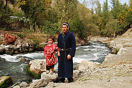 tajikistan,penjakent,3,girls,in,colorful,traditional,dress,smiling